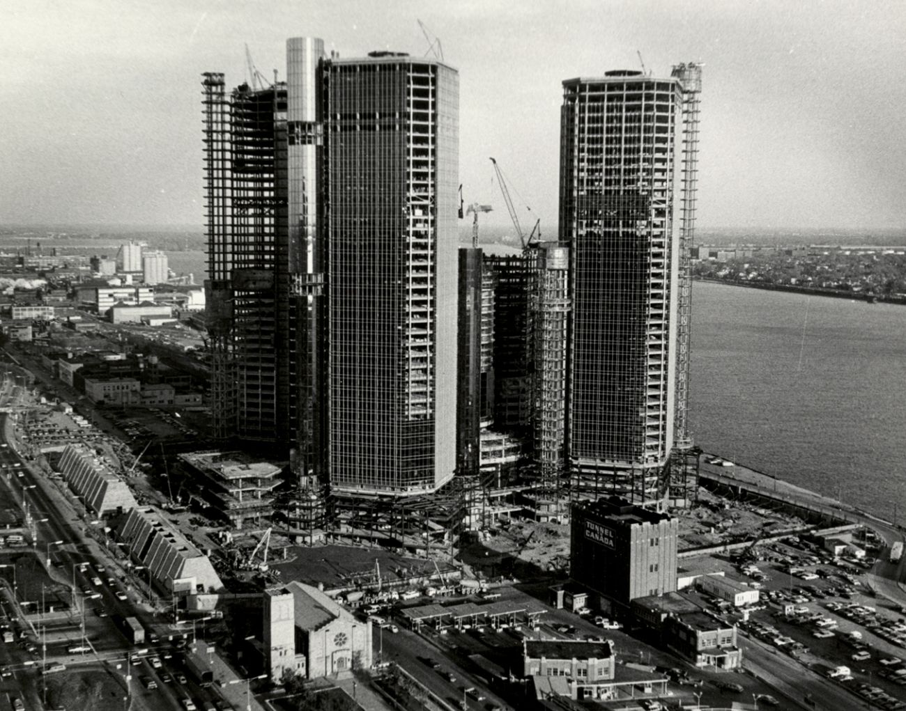 A black-and-white photo of Renaissance Center under construction in the 1970s.