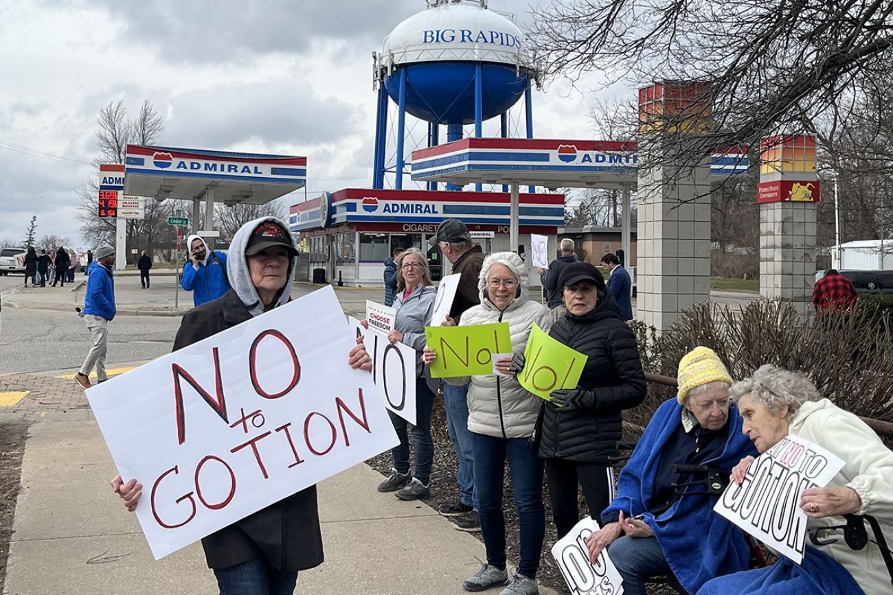 People holding signs that say "No Gotion" in Big Rapids, Michigan.
