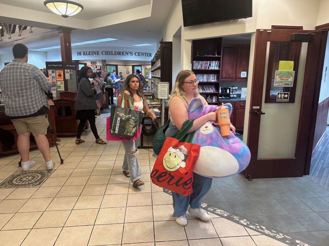Librarian Jordan Kazen carries items out of the Patmos Library in Ottawa County, Michigan.
