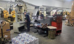 Mailroom crew members take copies of the Lenawee Voice off the press in the Tecumseh Herald newsroom