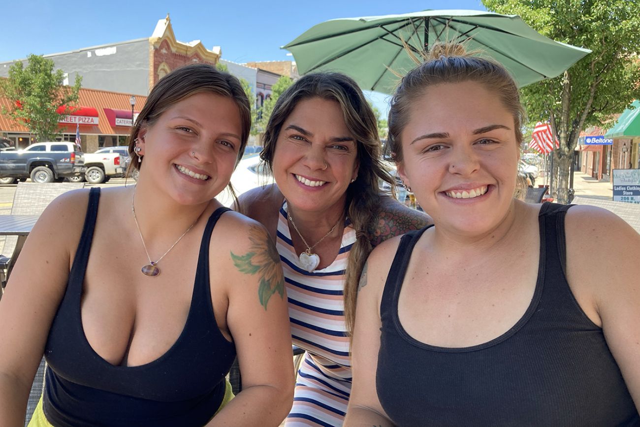 three woman standing by each other