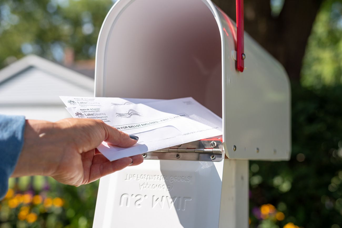 someone putting things in a mailbox