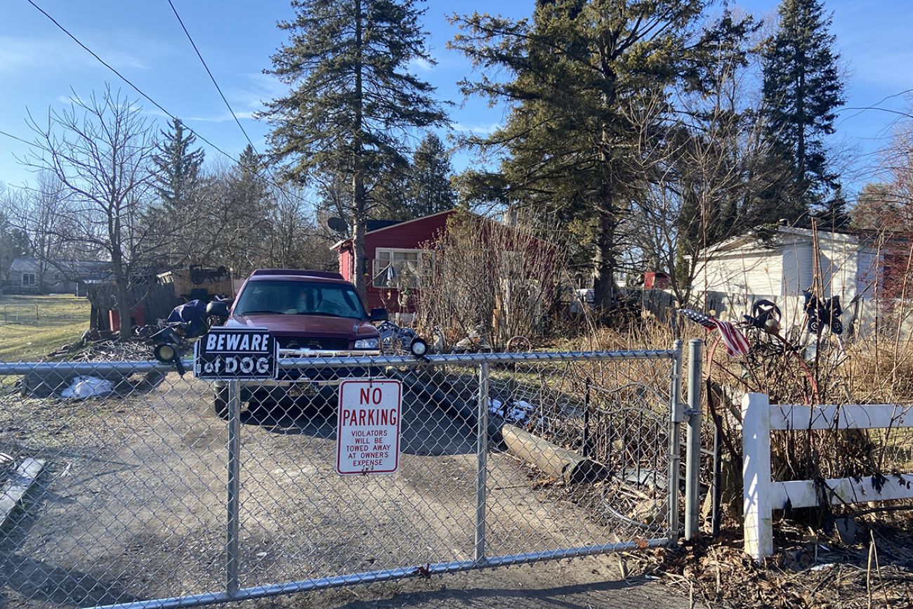 red house, a beware of the dog sign can be seen