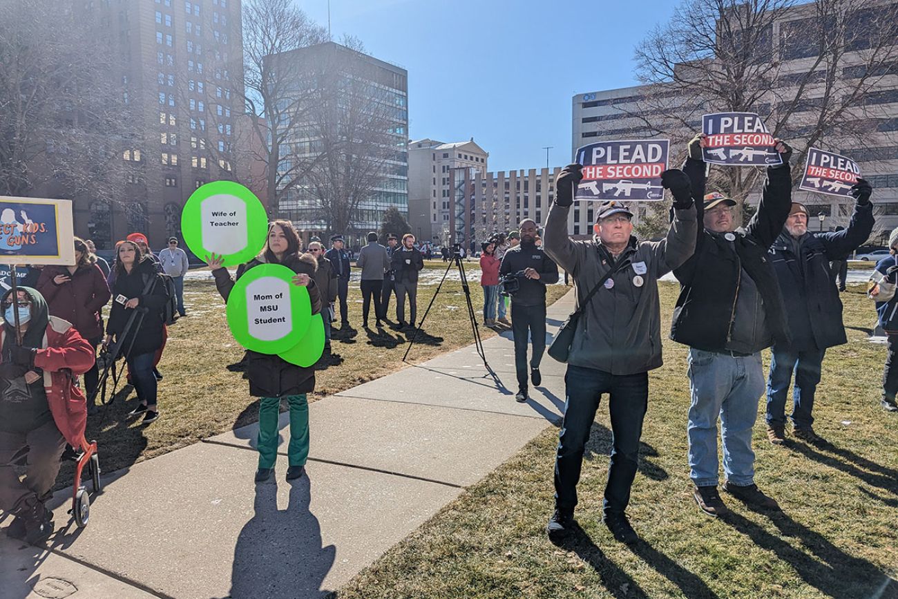 people holding pro gun rights signs