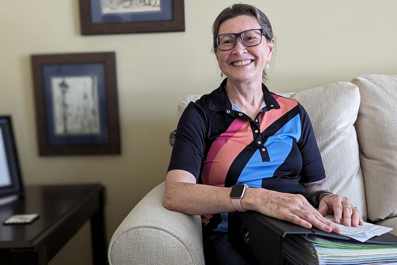 Rene Shireman smiling on the couch