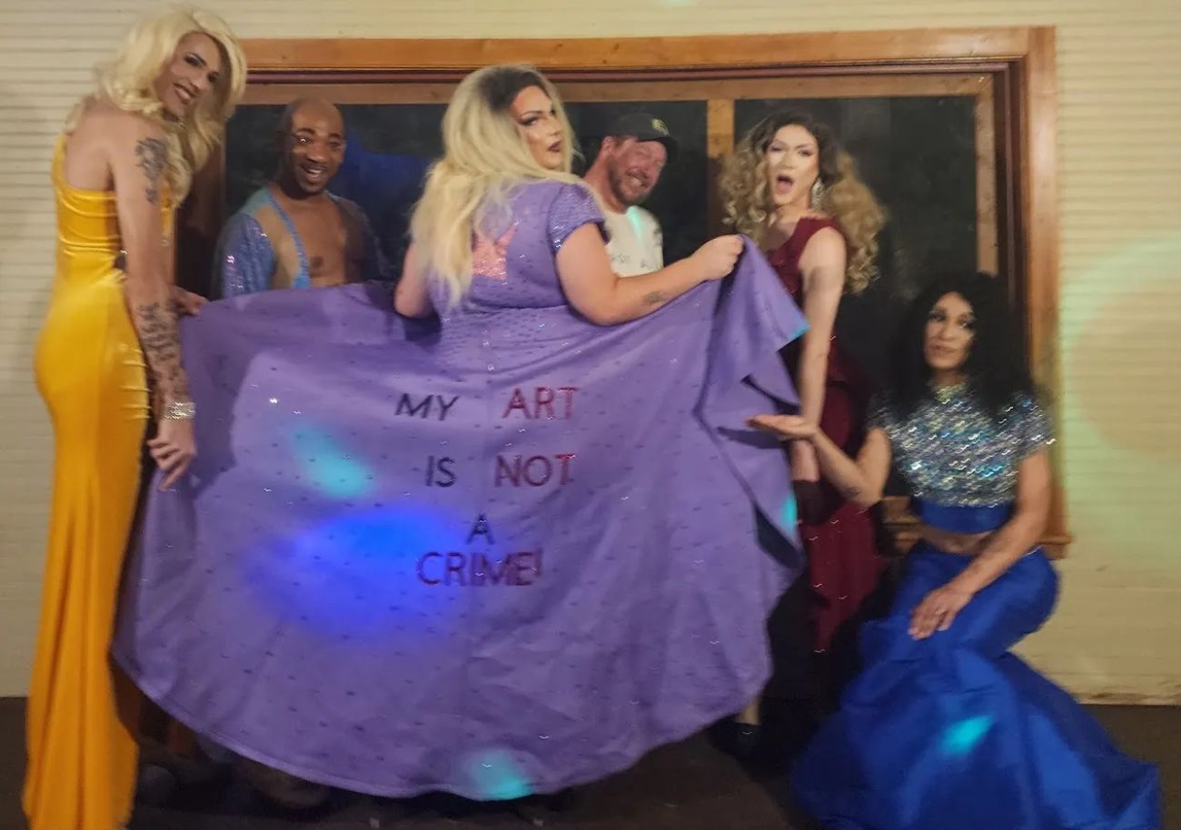 Teens dressed in drag, posing for a picture