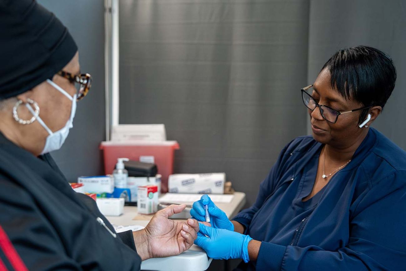 Patricia Adams, a registered nurse, pricks the finger of a patient at New Hope Missionary Baptist of Wayne