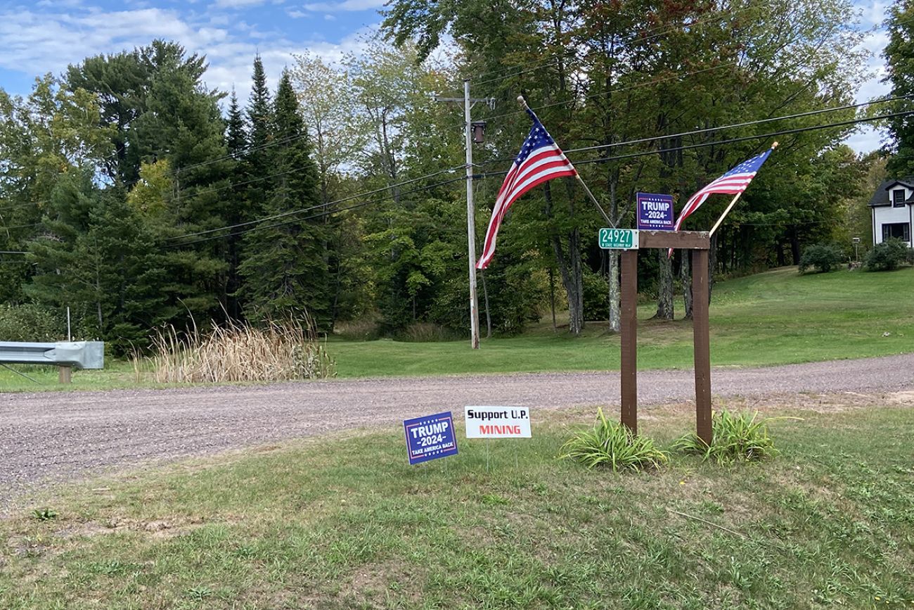 A support mining sign on a lawn. 