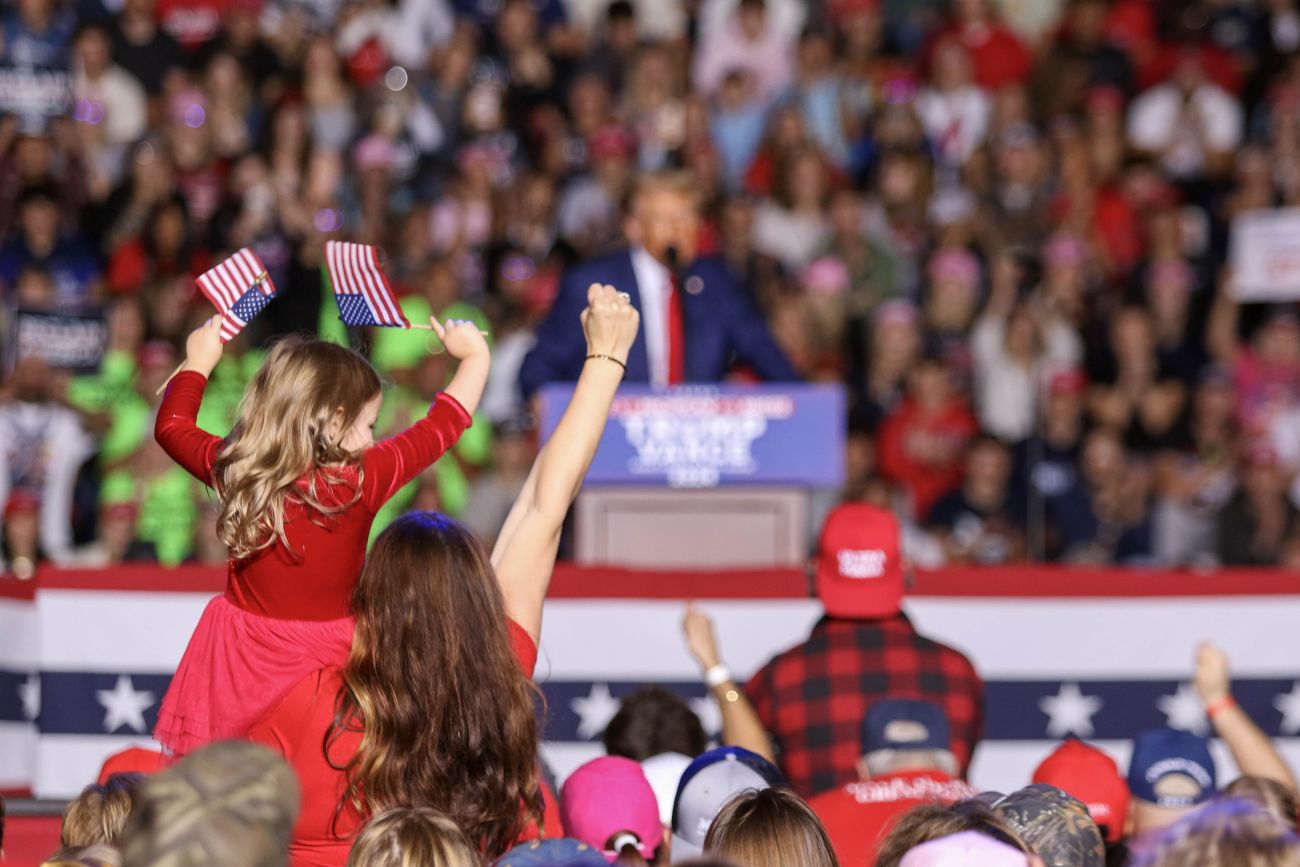 A little girl with her fist up at a Trump rally 