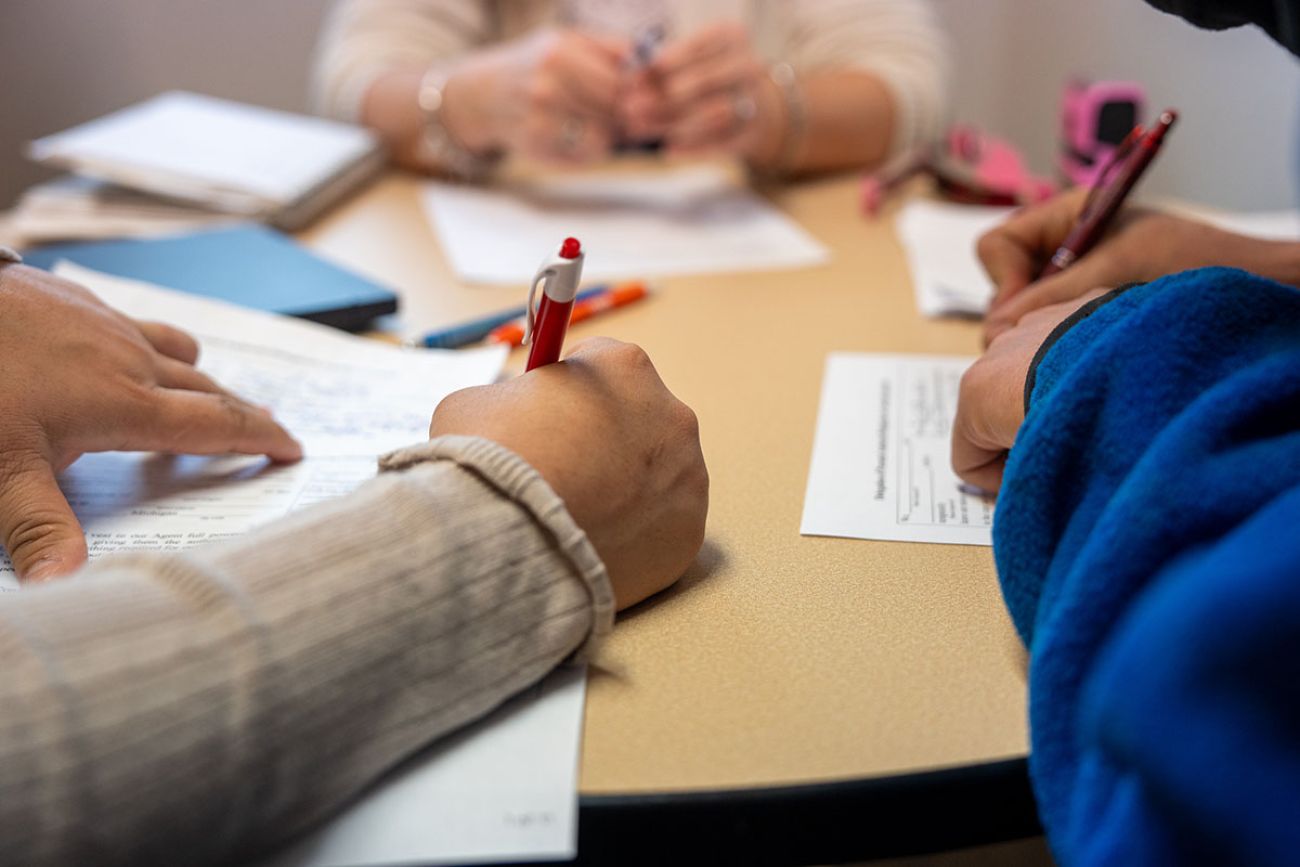 People filling out paperwork. 