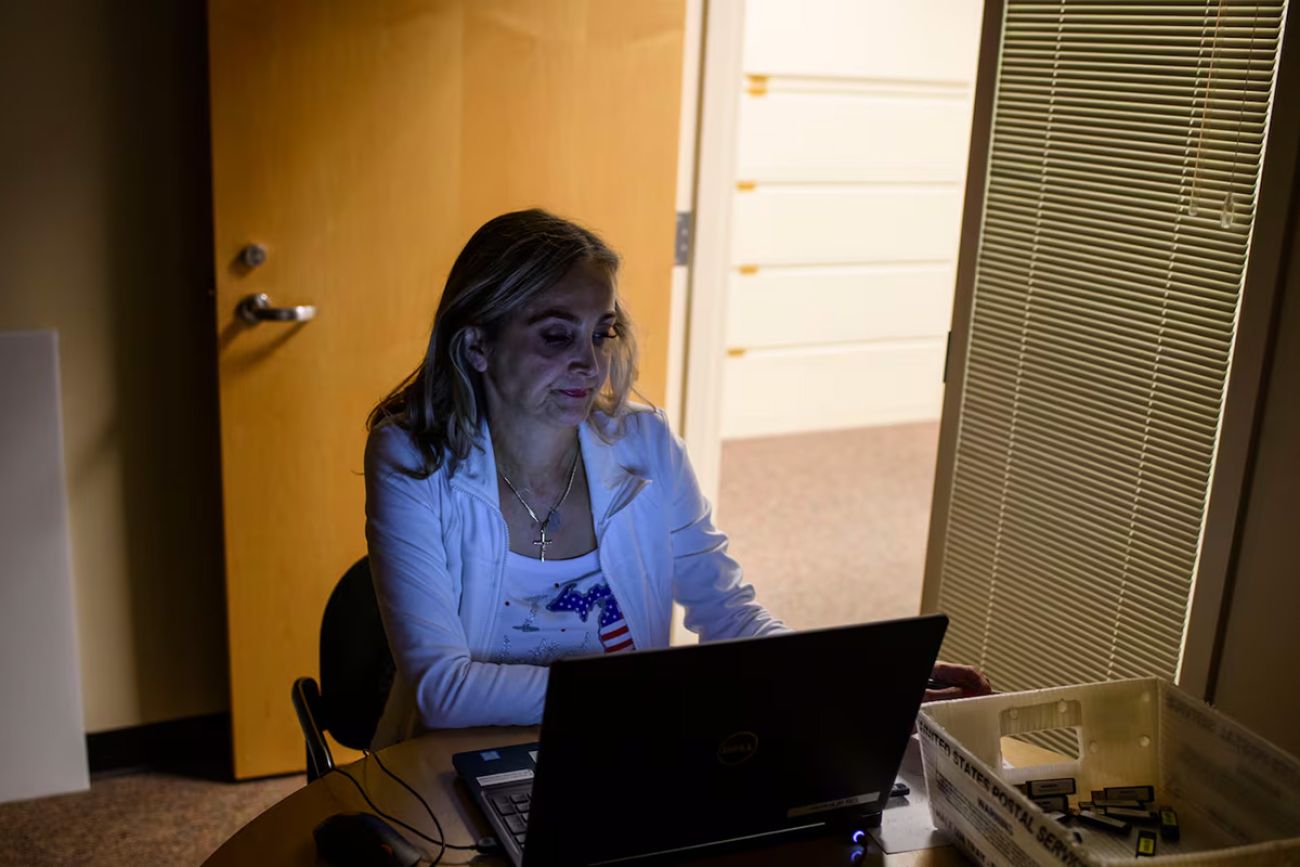 A woman working at a computer. 