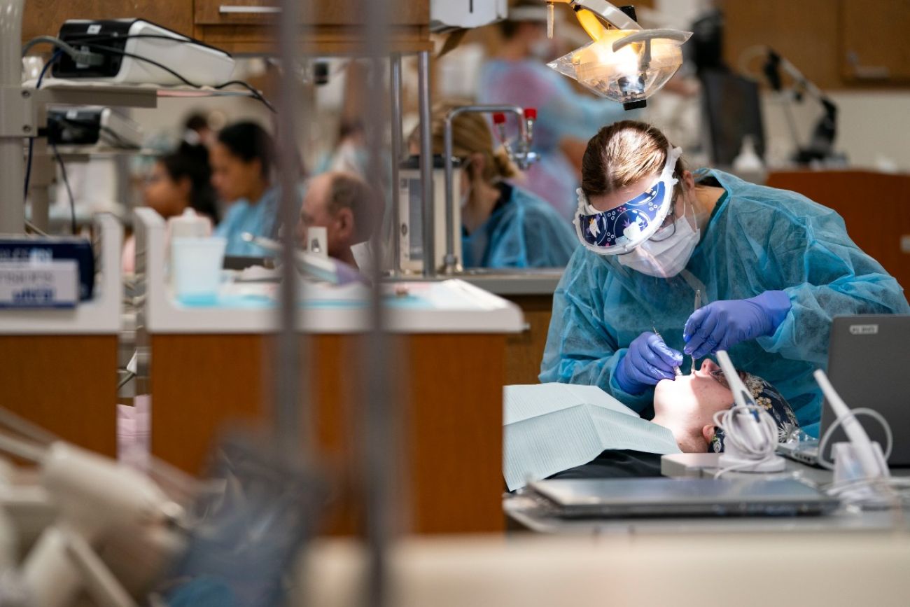 Dental hygienist student cleans teeth