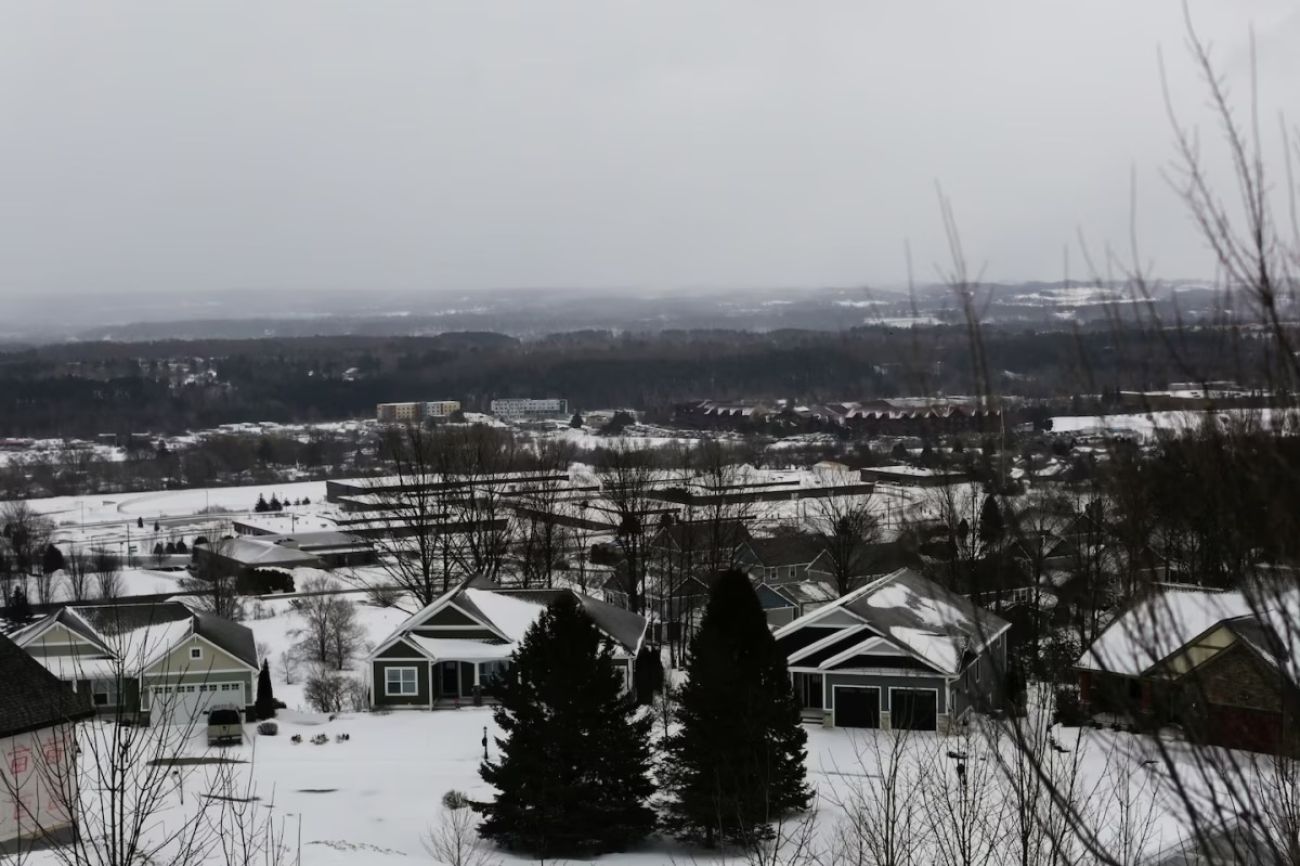 An aerial view of a snow-covered neighborhood. 