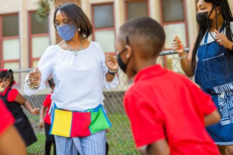 Educators and students celebrate the first day of school at Paul Robeson Malcom X Academy in Detroit.