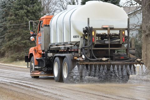 truck spraying brine on the road