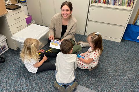 Sephanie Kosdrosky sitting down with kids