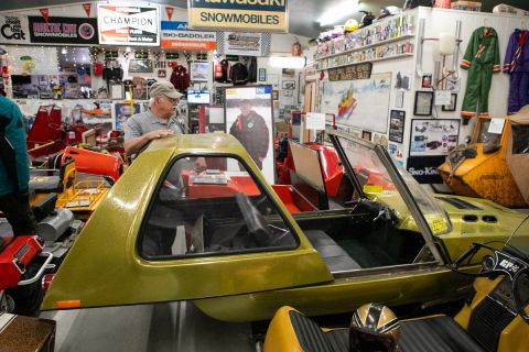 A yellow snowmobile that looks like a car