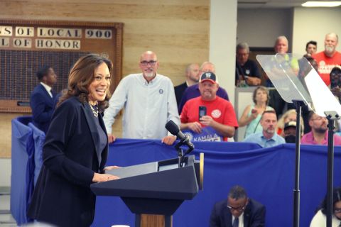 Kamala Harris, wearing a dark blue pant suit, speaks to supporters