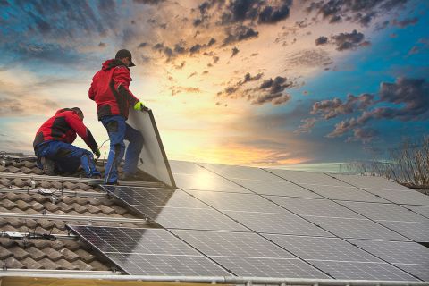 People working on a solar roof