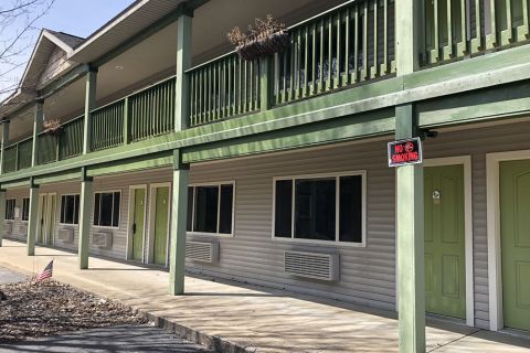 A closed green-colored motel. 