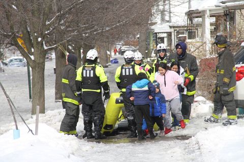 Residents next to rescue crews in Detroit. 