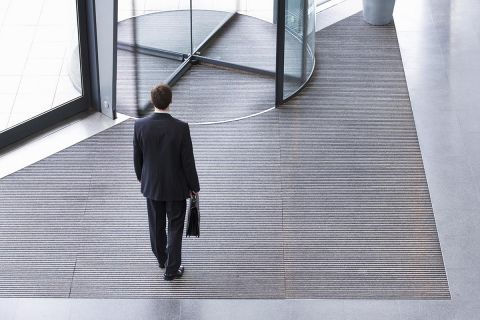 man standing in front of a revolving door