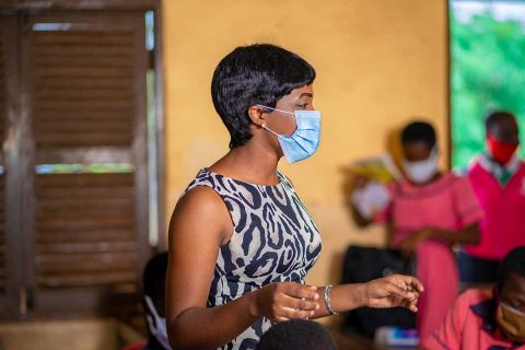 masked teacher in classroom