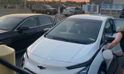 White Chevy Bolt being recharged at a Meijer gas station.