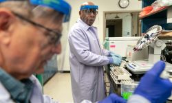 Two men stand in a lab