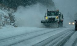 Snowplows work to clear snow off road