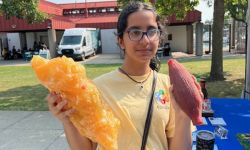 Simran Adnani hold an ear of corn and a blob of fat. 