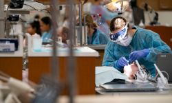 Dental hygienist student cleans teeth