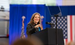 Michigan Secretary of State Jocelyn speaks into a microphone. 