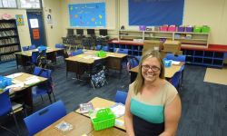 Leslie Moore sitting in her fourth-grade classroom